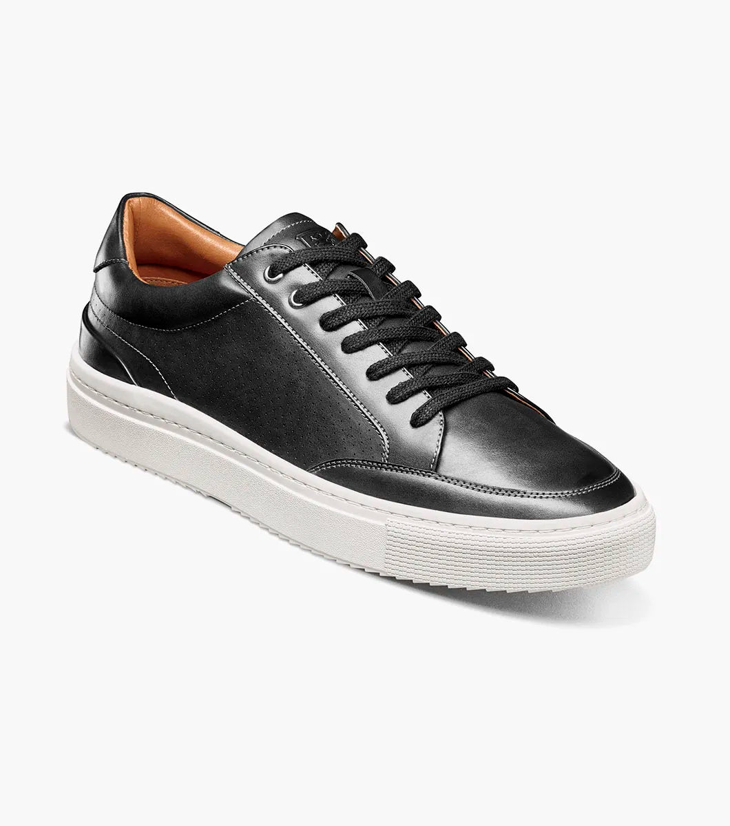 The STACY ADAMS Dorian Moc Toe Lace Up (25749-001) is a black leather court shoe with black laces, tan interior lining, arch support, and a thick white rubber sole, shown on a plain white background.