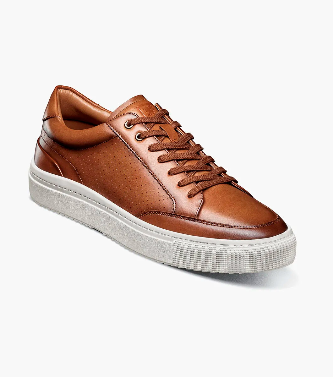 The Stacy Adams Dorian Moc Toe Lace Up in Cognac (25749-221) features brown leather, moc toe lace up design with matching laces, removable footbed, and a white rubber sole. Shown on a plain white background.