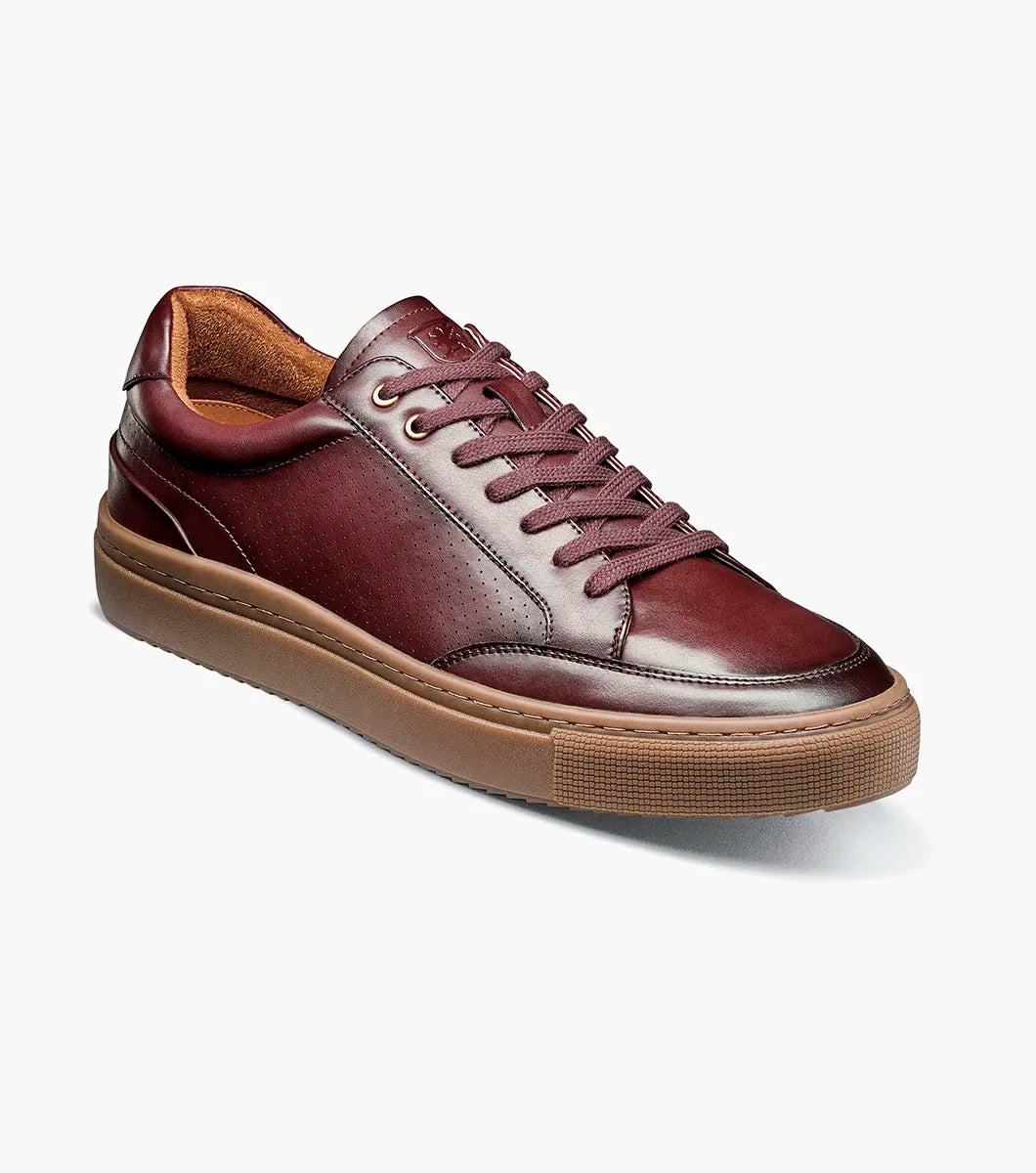 A single STACY ADAMS Dorian Lace To Toe Sneaker in Bordeaux leather (style 25749-646) is shown with brown laces and a thick brown rubber sole against a white background. This sneaker features anatomical arch support and a RedZone removable footbed for enhanced comfort.