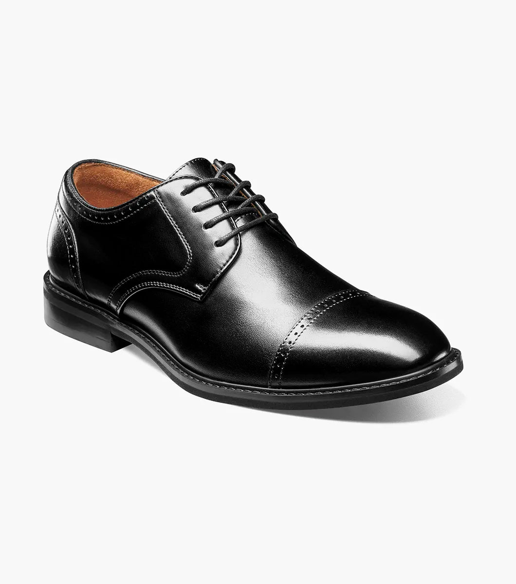 The Stacy Adams Bailey Cap Toe Oxford (25750-001) is a black leather dress shoe with laces, stitched detailing, and anatomical arch support, shown on a white background.