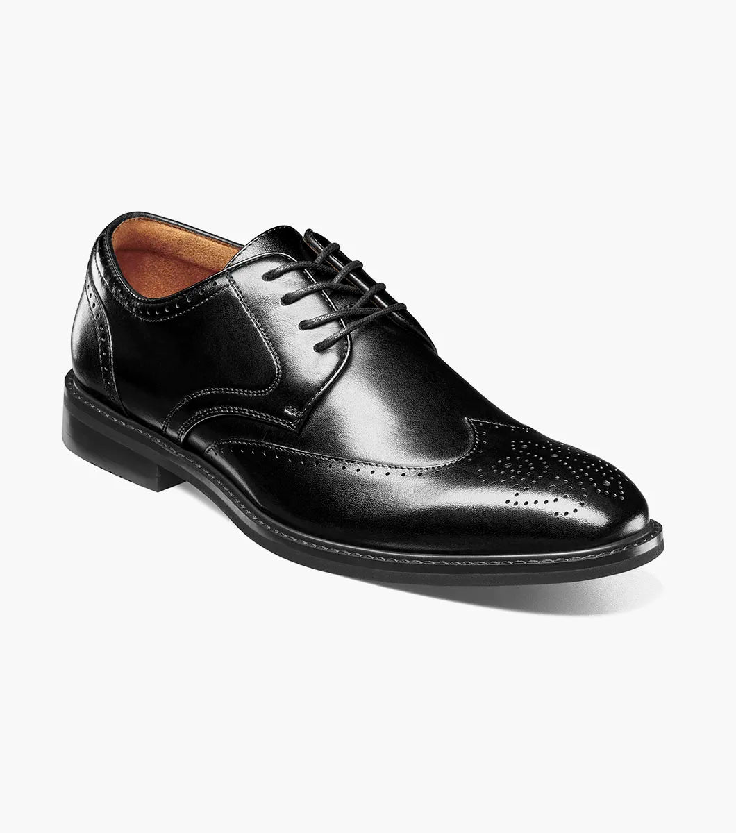 The Stacy Adams Bennett Wingtip Oxford (25752-001) is a black leather dress shoe with brogue detailing, lace-up closure, and brown lining by STACY ADAMS, shown on a white background.