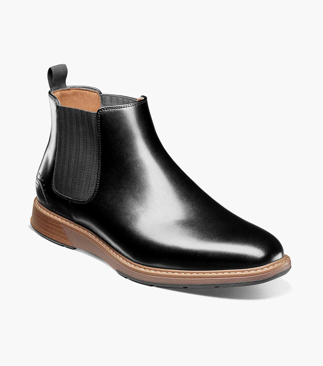 The STACY ADAMS Platt Plain Toe Chelsea Boot (Black, 25755-001) features sleek leather, elastic side panels, a brown sole, and a back pull tab—an elegant choice for any men’s boot collection.