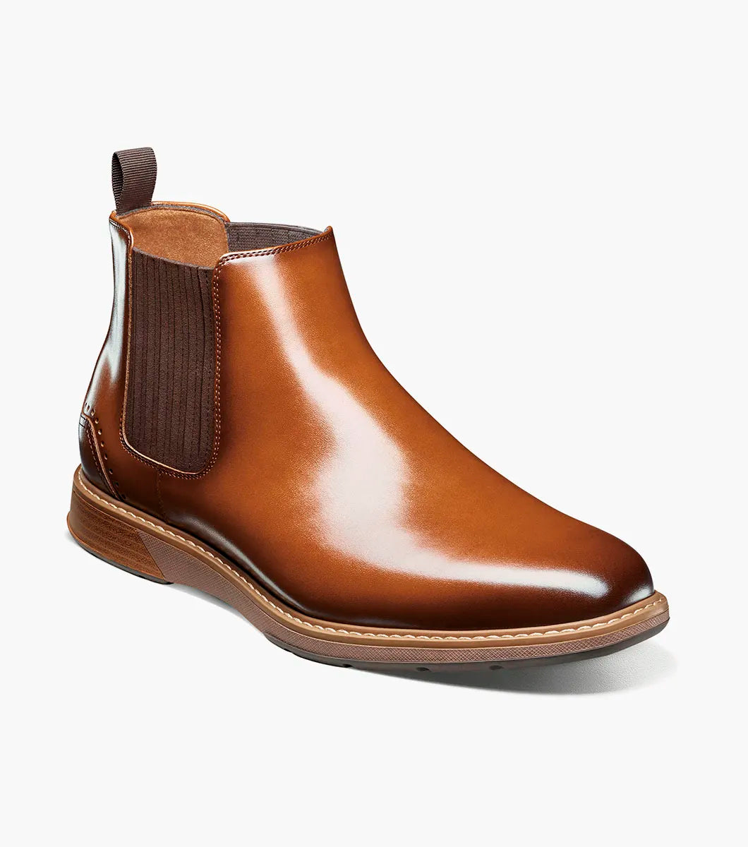 The Stacy Adams Platt Plain Toe Chelsea Boot in cognac features elastic side panels, a back pull tab, low stacked heel, and a RedZone removable footbed; shown on a white background.