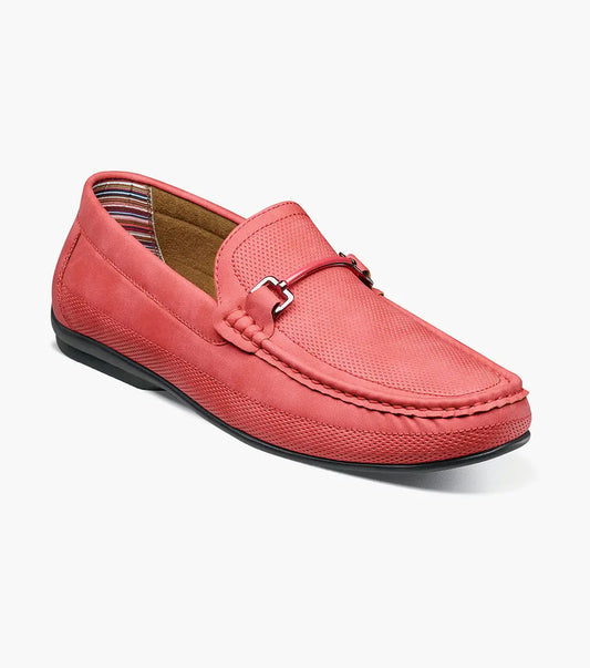 The Stacy Adams Colton Moc Toe Bit Slip On (25760-600) is a red suede loafer featuring a metal bit detail, visible stitching, black sole, striped inner lining, and cushioned footbed for comfort.