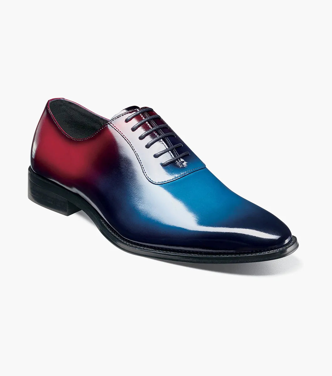 The STACY ADAMS Shaffer Plain Toe Oxford (Navy Multi, 25763-492) features premium calf leather with a gradient from deep red heel to blue toe, dark laces, and a black sole.