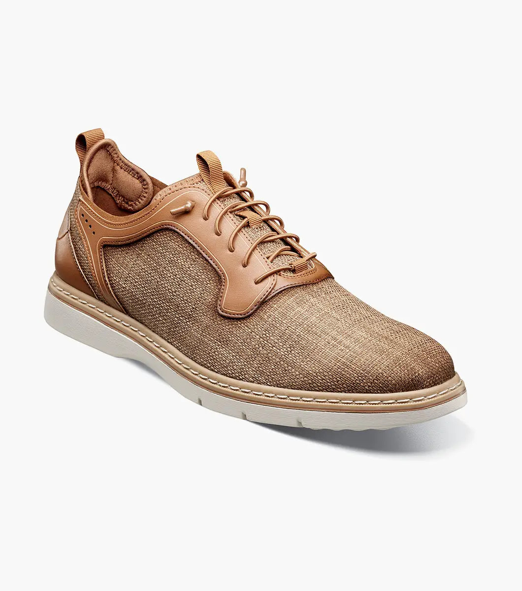 The Stacy Adams Sebert Plain Toe Elastic Lace Up in tan features a textured fabric upper, leather accents, anatomical arch support, and a light rubber sole for comfort, shown on a white background.