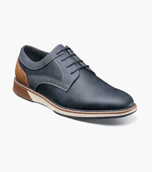 The Stacy Adams Phineas Plain Toe Oxford in navy features tan heel and sole accents, a textured upper, lace-up closure, and cushioned insole for comfort.