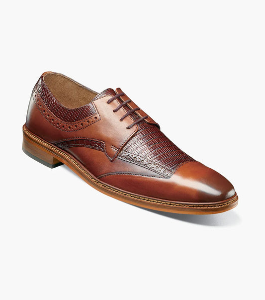 The Stacy Adams Gambetta Modified Cap Toe Oxford in cognac features textured detailing, lace-up closure, and a low heel, displayed on a white background.