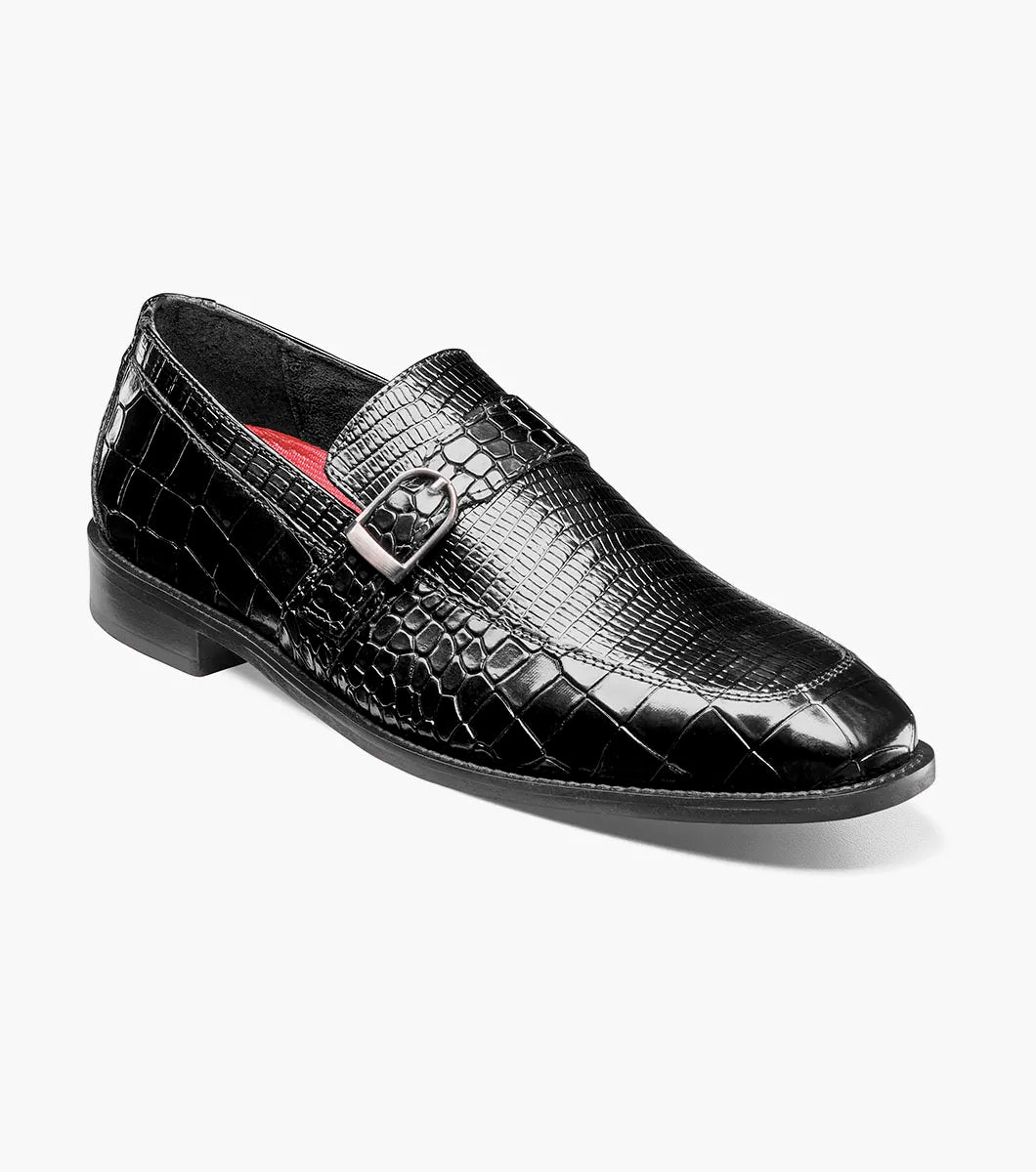 The Stacy Adams Rubiano Moc Toe Buckle Strap Slip On in black (style 25787-001) by STACY ADAMS features a black crocodile print leather pattern, a silver buckle strap slip-on design, and a low heel, displayed on a plain white background.