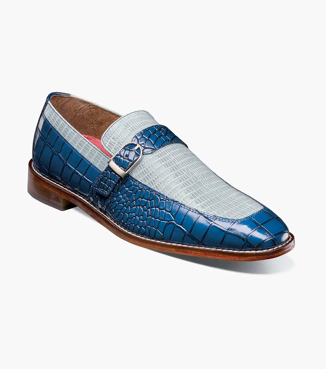 Introducing the STACY ADAMS Rubiano Moc Toe Buckle Strap Slip On in Dark Blue Multi (Style 25787-469)—a men’s loafer featuring a striking blue crocodile print leather overlay, a gray patterned upper, a moc toe slip-on design, side buckle strap detail, and a brown sole.