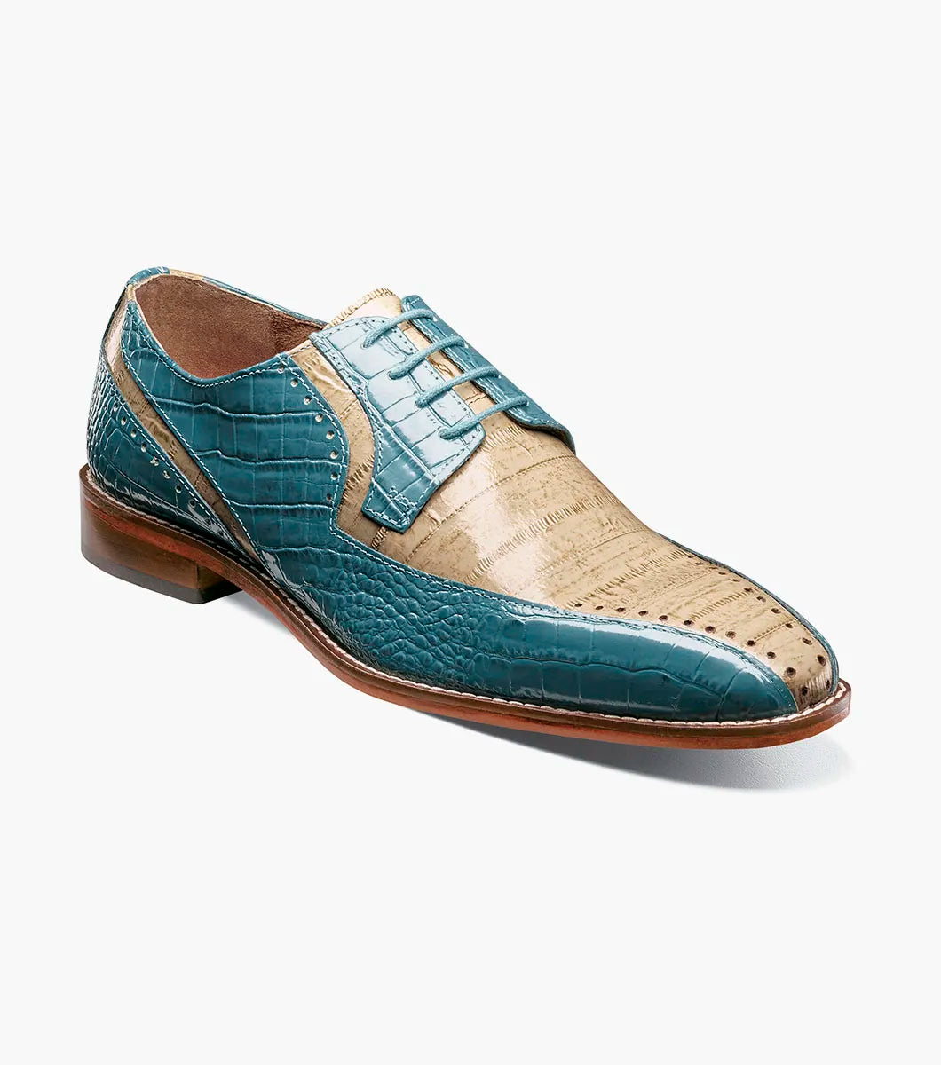 The Stacy Adams Talamanco Bike Toe Oxford in Teal Multi (Style 25788-448) features a sophisticated blend of teal blue and beige crocodile-textured leather, detailed with classic broguing and set atop a brown sole—combining timeless elegance with everyday comfort for any occasion.