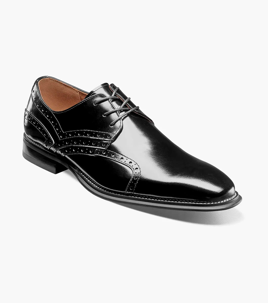 The STACY ADAMS Alexander Plain Toe Oxford in black (style 25791-001) is an elegant calf leather dress shoe with laces, decorative perforations, a low heel, and a comfortable memory foam insole, displayed on a light background.