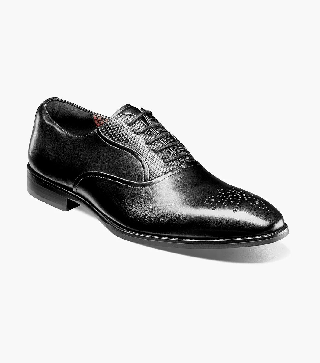 The STACY ADAMS Langford Plain Toe Oxford in black (25795-001) is a classic leather dress shoe featuring perforated toe detailing and black laces, designed to provide both style and comfort for any formal occasion. Shown on a white background.
