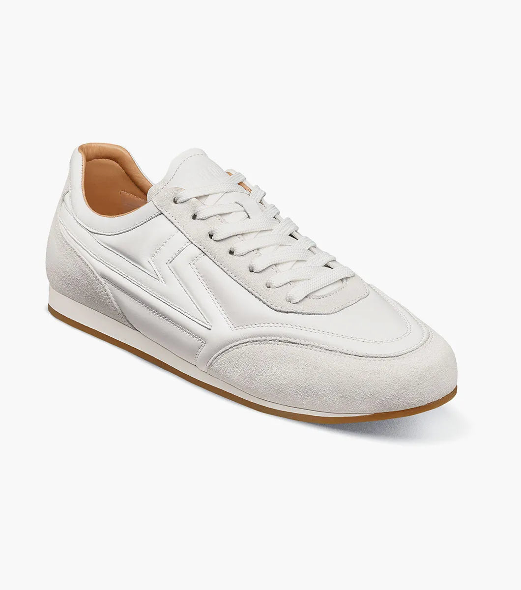Introducing the Stacy Adams Action 150 Sporty Lace Up in White (style 25797-100), these men’s sneakers from STACY ADAMS feature a low-top silhouette with white laces, suede accents around the toe, a gum sole, and a subtle embossed design on the side. Photographed on a clean white background, these casual sneakers offer timeless style and sporty details for versatile everyday wear.