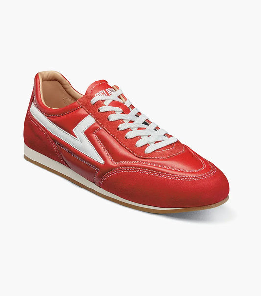 Introducing the STACY ADAMS Action 150 Sporty Lace Up in red (style 25797-600), a modern sneaker highlighted by sporty white laces and a distinctive white zigzag pattern along the side, displayed against a plain white background. The cushioned footbed provides comfort with every step.