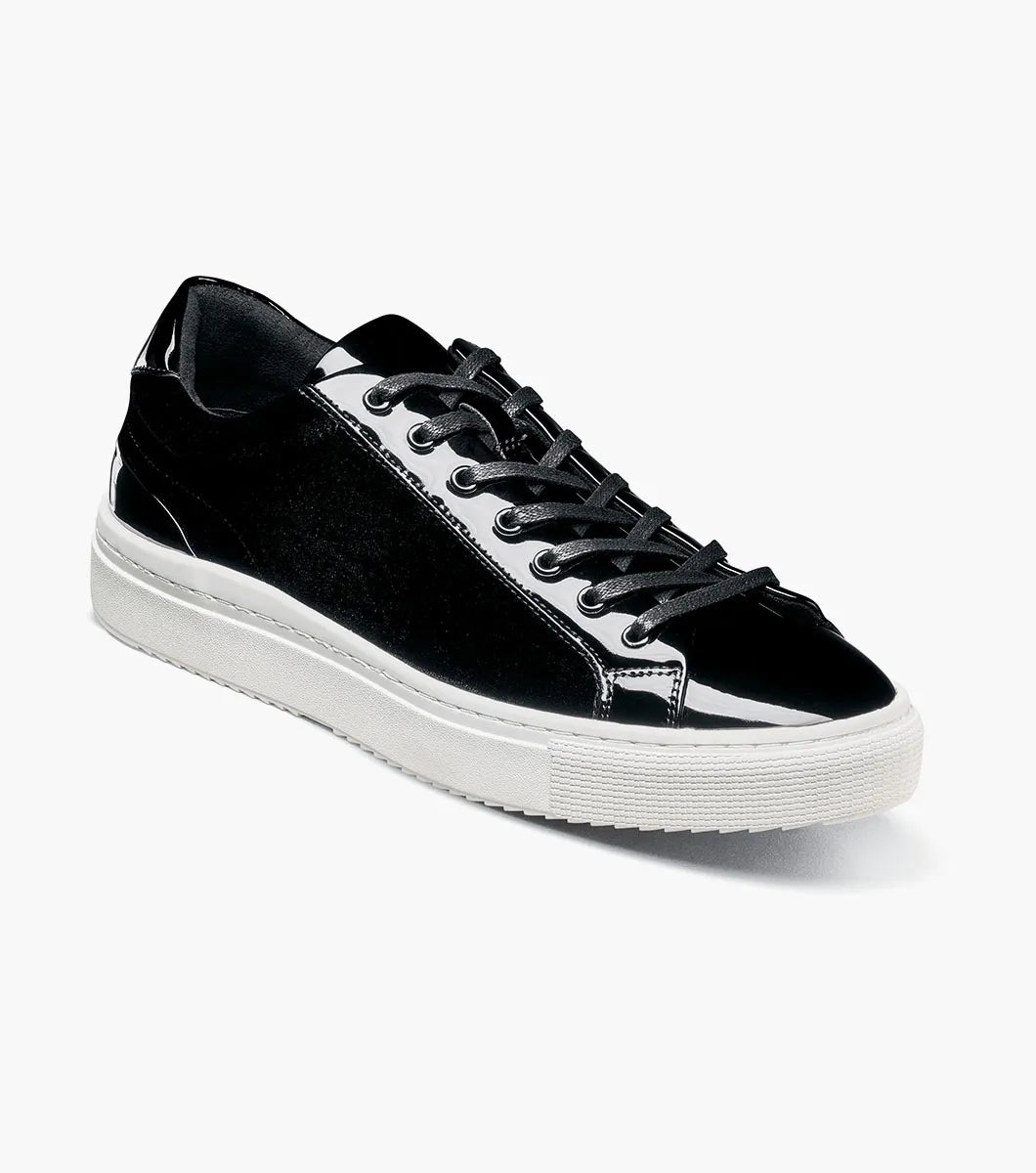A Stacy Adams Dante Lace To Toe Sneaker in black (style 25806-001) is shown on a white background, featuring shiny patent leather accents, black laces, and a white rubber sole.