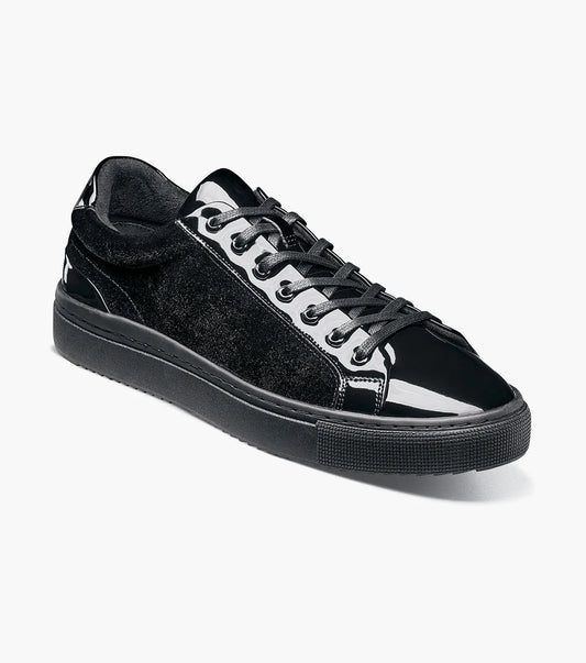 The Stacy Adams Dante Lace To Toe Sneaker in Black Smooth (Style 25806-005) features glossy patent leather and suede paneling, black laces, and a black rubber sole. Displayed on a white background, this STACY ADAMS low-top sneaker offers a sleek lace-to-toe design.