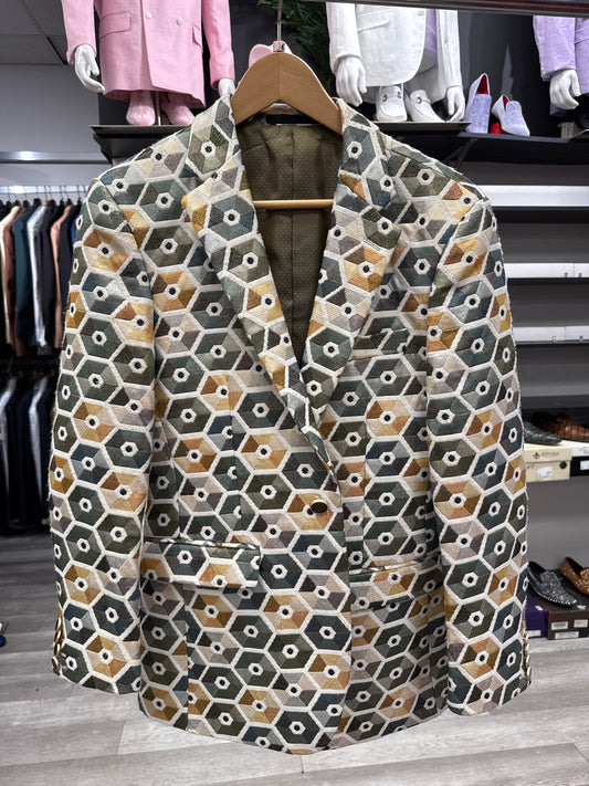 JACKET 15 CLEARANCE by EJ SAMUEL—a geometric-patterned blazer featuring green, white, yellow, and beige hexagons—hangs on a wooden hanger in the clothing store. Please note: this item is final sale—no returns or exchanges.