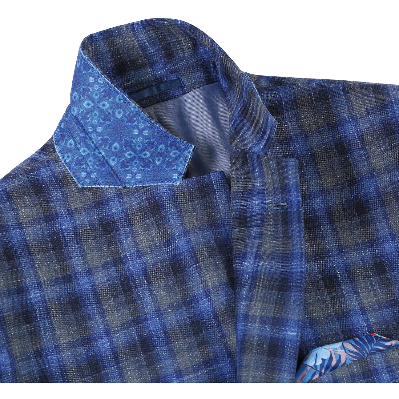 The Alessandro Vitello by Renoir Slim Fit Wool Blend Checked Blazer Blue 563-1 is displayed on a mannequin, highlighting its plaid pattern and notch lapel. Styled with a white shirt and dotted tie, it elegantly showcases the blazer’s slim fit design.