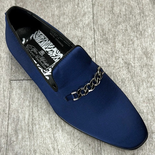 The Exclusive Formal Dress Shoe Blue 7021 by UNIQUE DESIGN MENSWEAR, crafted from genuine suede leather and adorned with a silver chain detail on the upper, rests elegantly on a gray wooden floor.