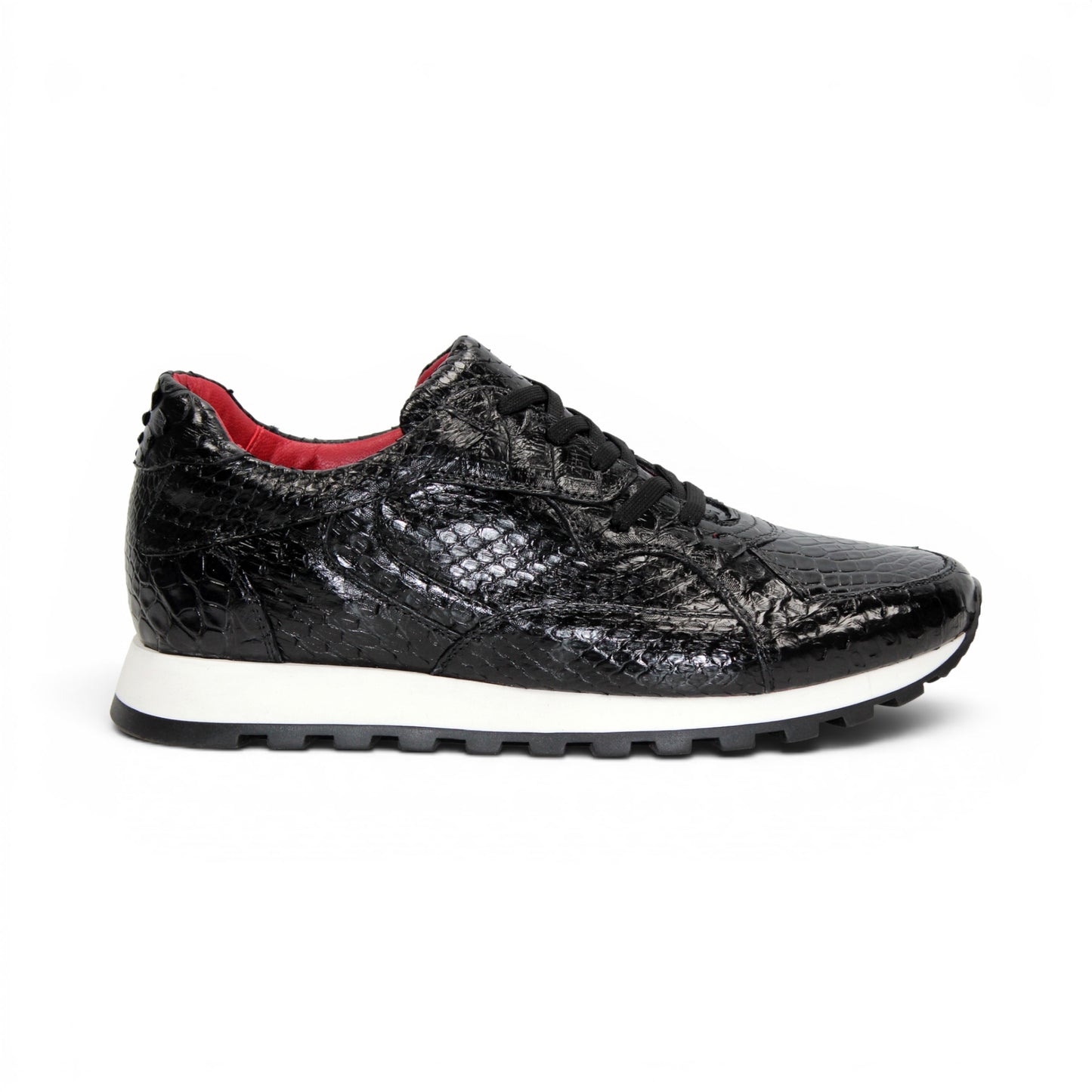 The Fennix 3538 Black sneaker by Fennix of Italy features a black textured upper, white sole, black laces, and a subtle red interior lining. Shown in a left side profile view against a plain white background, this shoe exemplifies Italian craftsmanship and meticulous attention to detail.