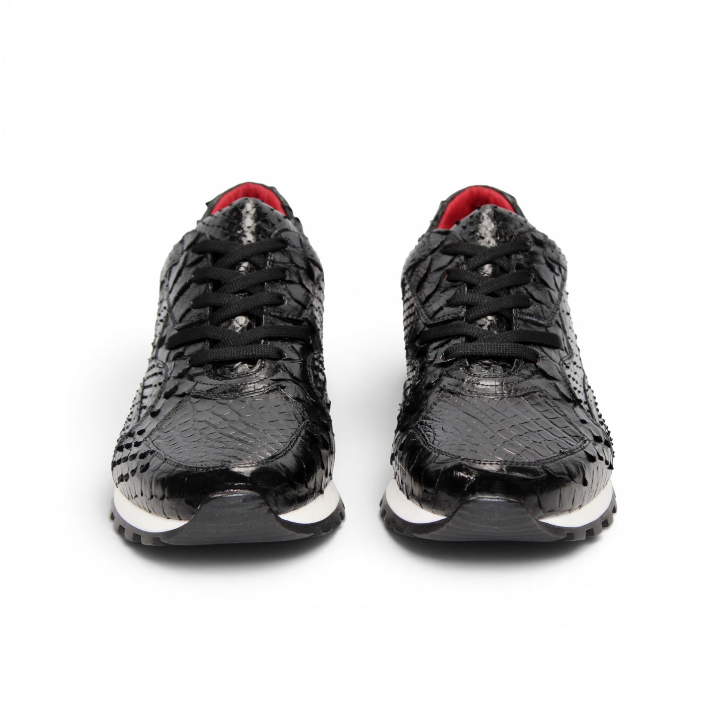The Fennix 3538 Black sneaker by Fennix of Italy features a black textured upper, white sole, black laces, and a subtle red interior lining. Shown in a left side profile view against a plain white background, this shoe exemplifies Italian craftsmanship and meticulous attention to detail.
