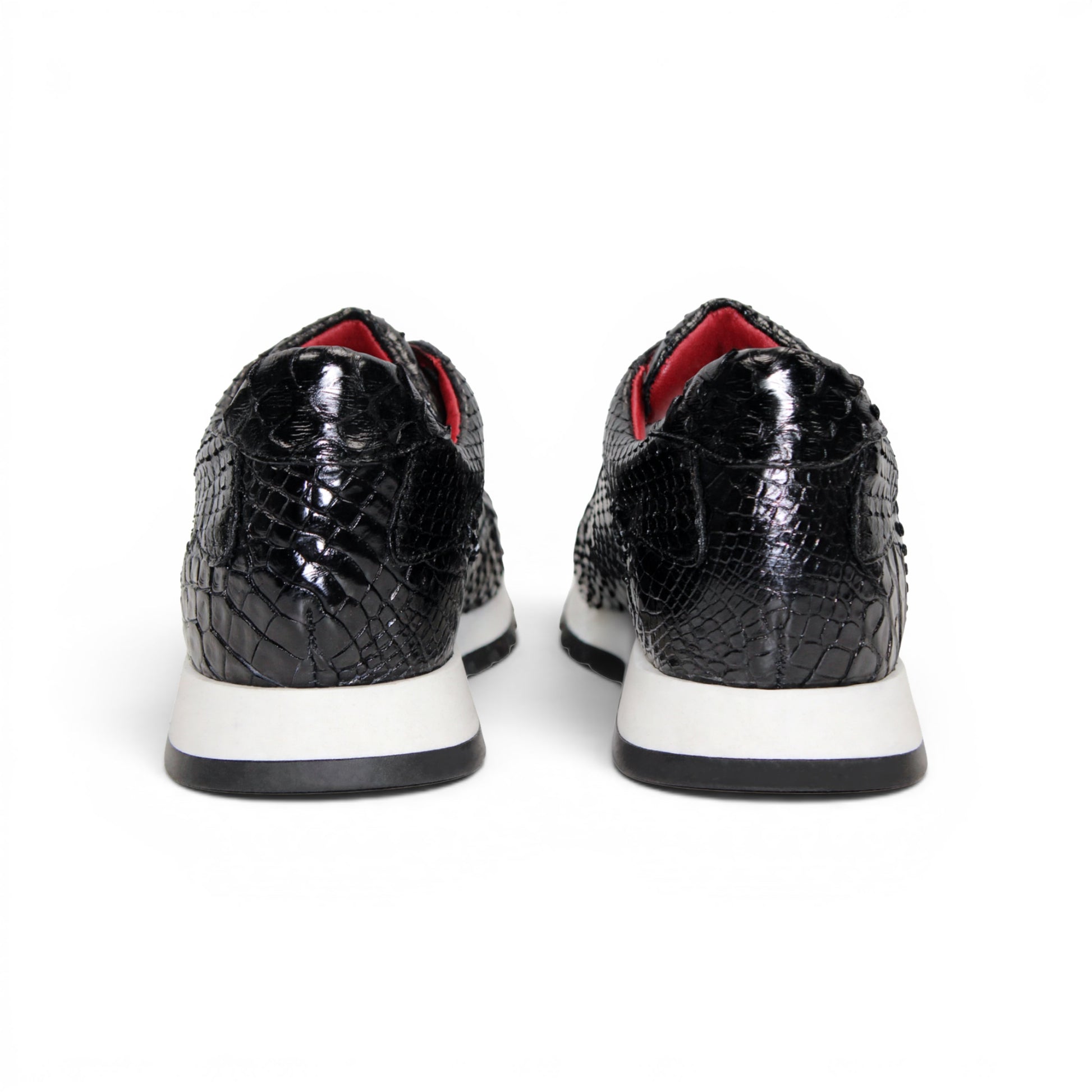 The Fennix 3538 Black sneaker by Fennix of Italy features a black textured upper, white sole, black laces, and a subtle red interior lining. Shown in a left side profile view against a plain white background, this shoe exemplifies Italian craftsmanship and meticulous attention to detail.