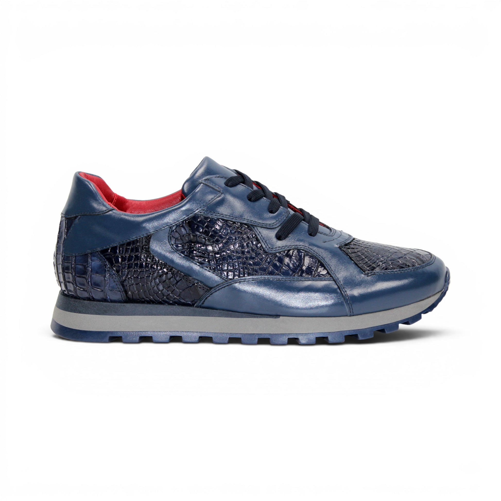 The Fennix 3538 Navy by Fennix of Italy features textured, crocodile-inspired navy blue panels, black laces, a red interior lining, and a grey sole. Shown in side profile against a white background, this sneaker exemplifies Italian craftsmanship and embodies the allure of exotic luxury footwear.
