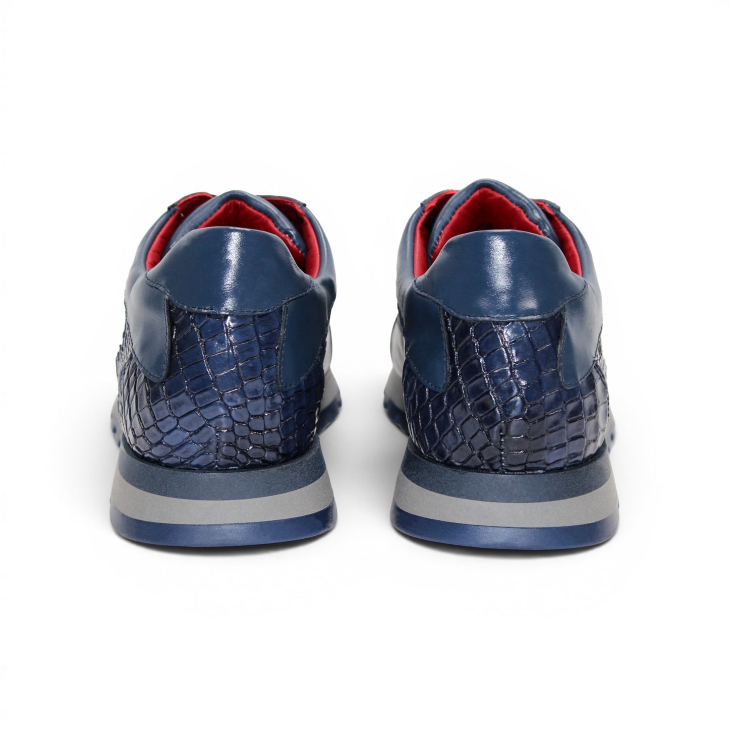 The Fennix 3538 Navy by Fennix of Italy features textured, crocodile-inspired navy blue panels, black laces, a red interior lining, and a grey sole. Shown in side profile against a white background, this sneaker exemplifies Italian craftsmanship and embodies the allure of exotic luxury footwear.