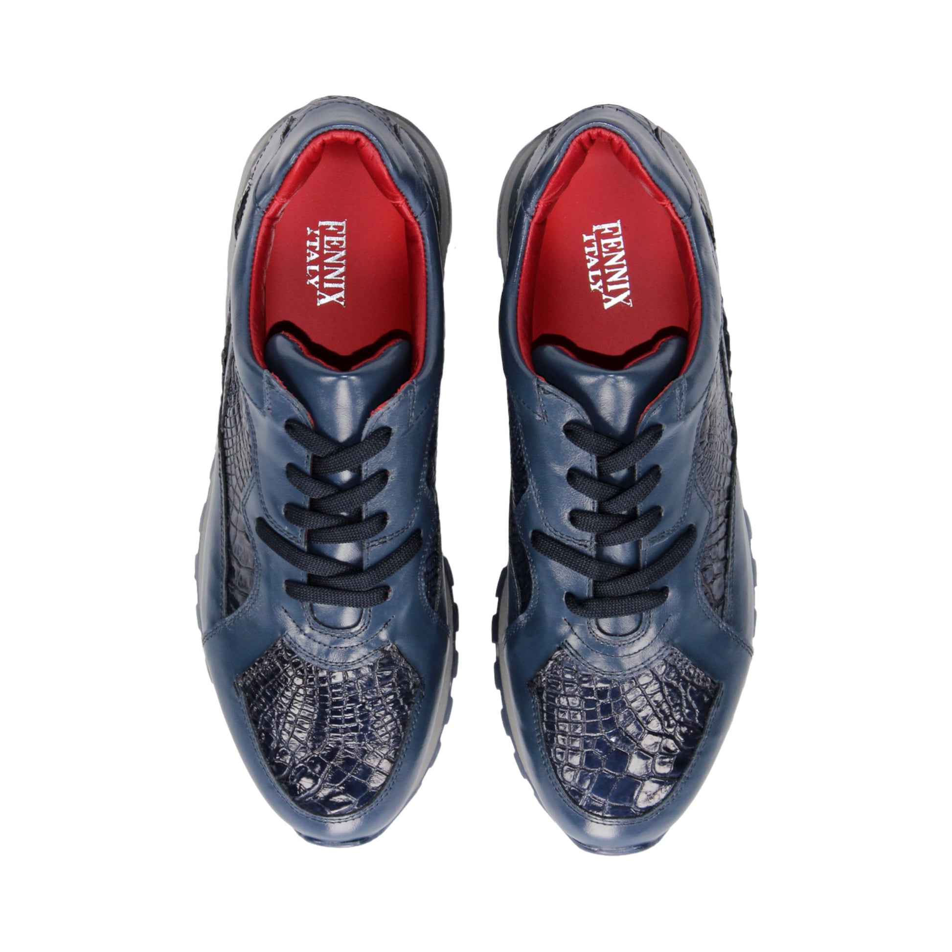 The Fennix 3538 Navy by Fennix of Italy features textured, crocodile-inspired navy blue panels, black laces, a red interior lining, and a grey sole. Shown in side profile against a white background, this sneaker exemplifies Italian craftsmanship and embodies the allure of exotic luxury footwear.
