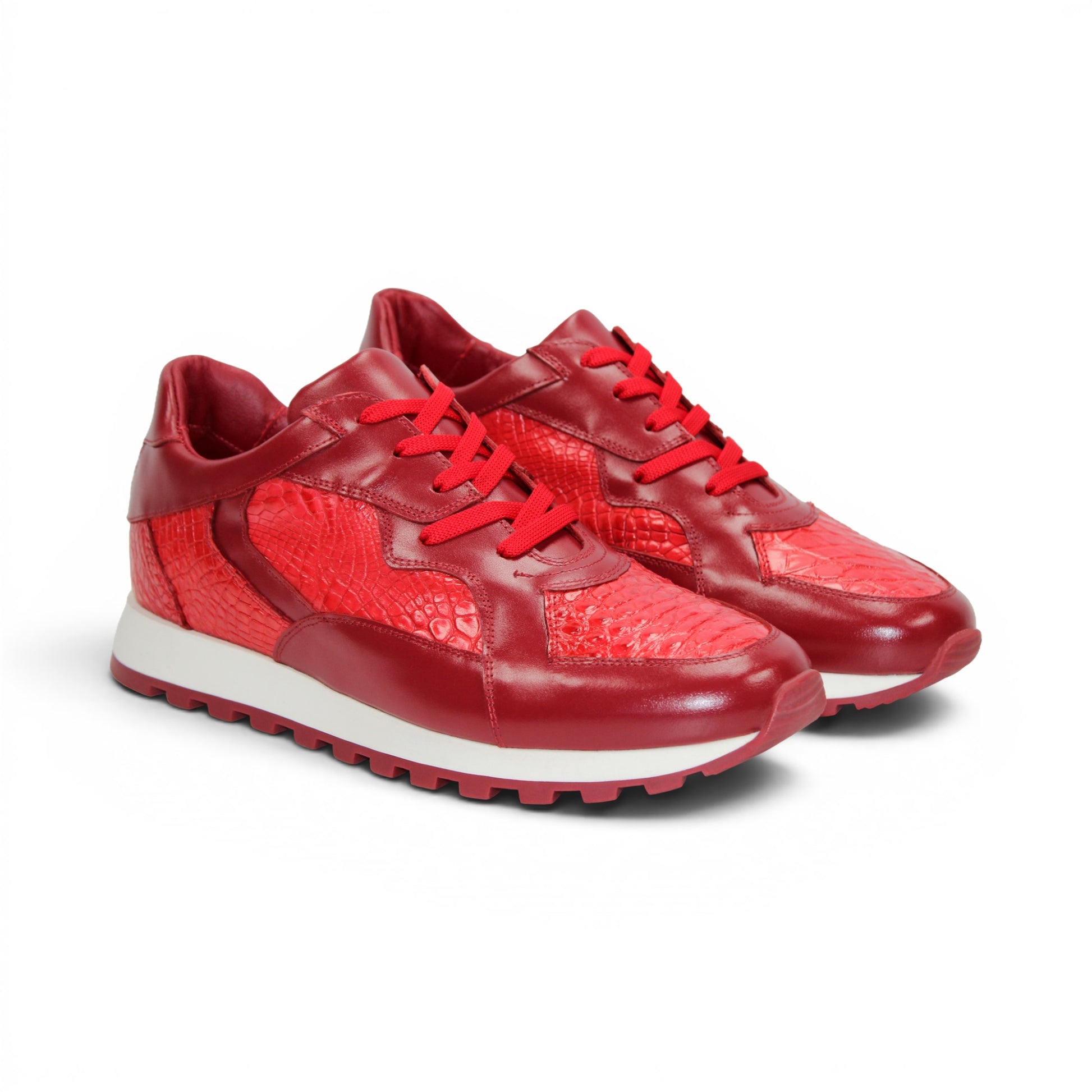 The Fennix 3538 Red by Fennix of Italy is a red athletic sneaker featuring a textured surface reminiscent of exotic leather, matching red laces, and a white midsole paired with a red outsole, displayed in profile view. Its expert craftsmanship provides a subtle nod to luxury Italian footwear, seamlessly blending style and sport in one sleek design.