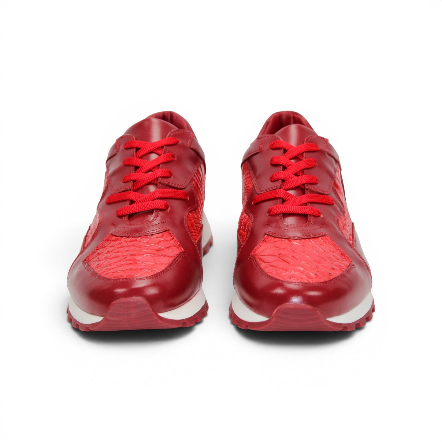 The Fennix 3538 Red by Fennix of Italy is a red athletic sneaker featuring a textured surface reminiscent of exotic leather, matching red laces, and a white midsole paired with a red outsole, displayed in profile view. Its expert craftsmanship provides a subtle nod to luxury Italian footwear, seamlessly blending style and sport in one sleek design.
