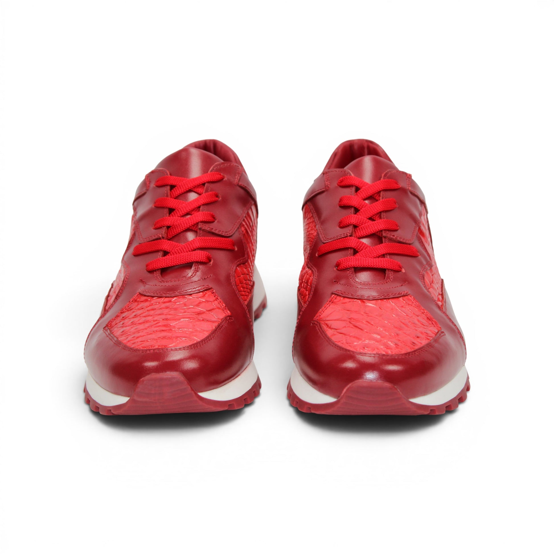 The Fennix 3538 Red by Fennix of Italy is a red athletic sneaker featuring a textured surface reminiscent of exotic leather, matching red laces, and a white midsole paired with a red outsole, displayed in profile view. Its expert craftsmanship provides a subtle nod to luxury Italian footwear, seamlessly blending style and sport in one sleek design.