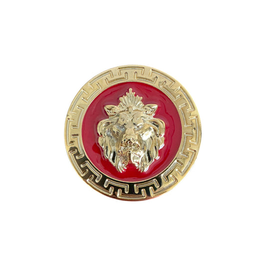 The Matiste Red/Gold Belt Buckle 35mm B35 features a gold lion head emblem on a red circular background with a gold Greek key border, perfect for adding bold style to any Matiste belt.