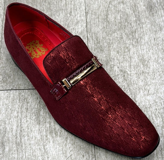 The Exclusive Formal Dress Shoe Burgundy 6993 by UNIQUE DESIGN MENSWEAR, featuring a shiny textured genuine leather and a decorative gold buckle, exudes Italian elegance as it rests on a light gray tile floor.