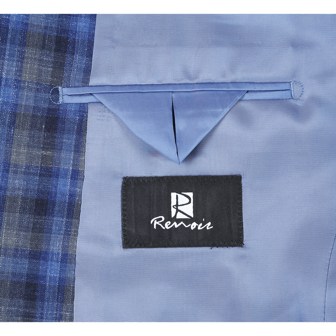 The Alessandro Vitello by Renoir Slim Fit Wool Blend Checked Blazer Blue 563-1 is displayed on a mannequin, highlighting its plaid pattern and notch lapel. Styled with a white shirt and dotted tie, it elegantly showcases the blazer’s slim fit design.