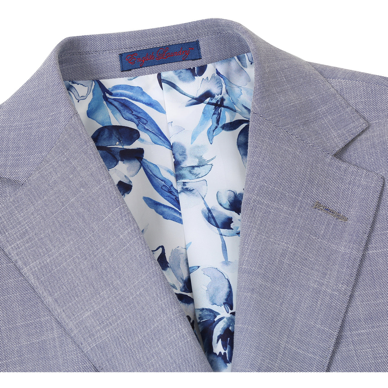 The ENGLISH LAUNDRY Light Gray Suit 32-02-002EL by English Laundry features notched lapels, two front flap pockets, a single button closure, and a blue and white floral patterned inner lining.