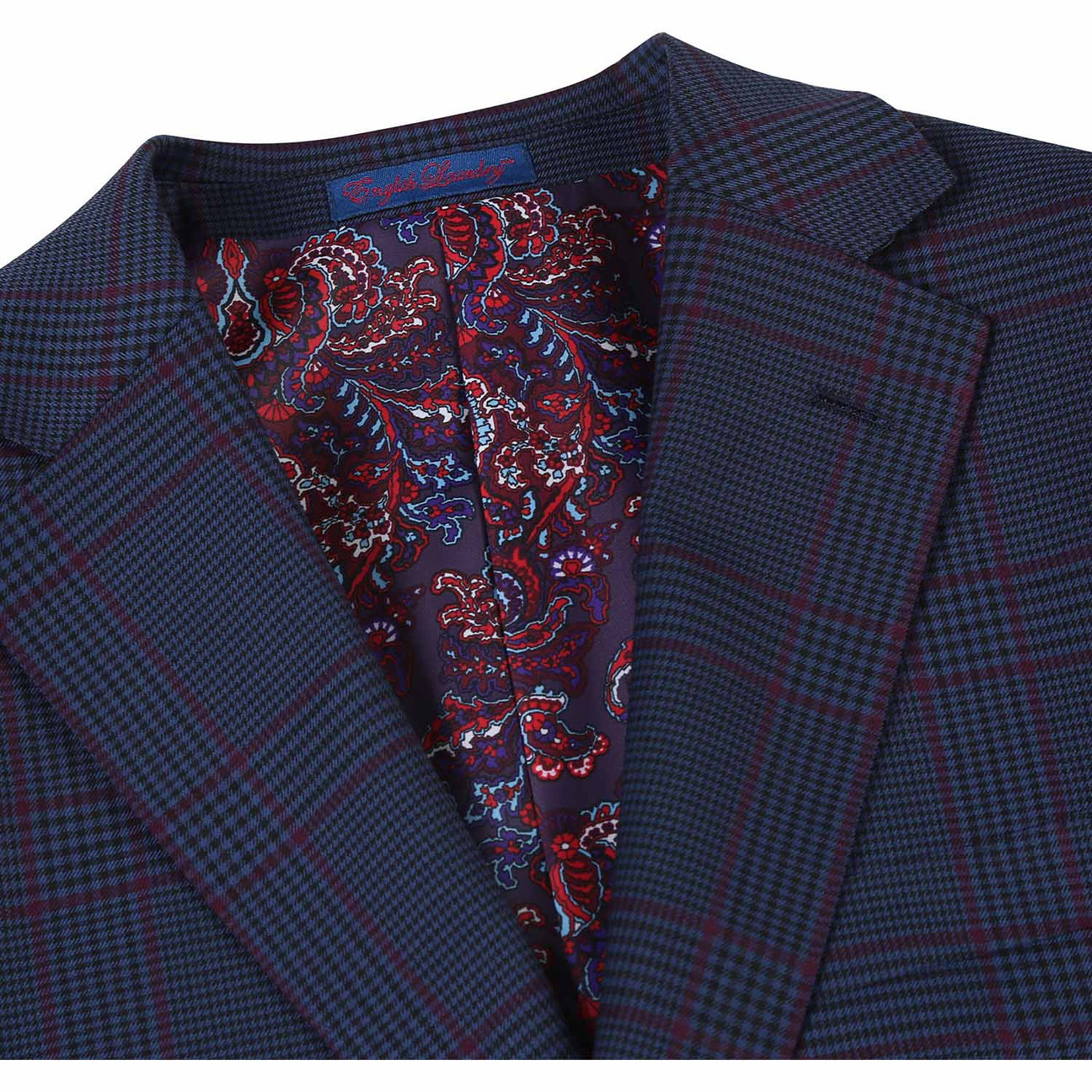 The mannequin displays an ENGLISH LAUNDRY Blue with Burgundy Check Suit, showcasing a slim fit and refined notch lapels. The ensemble is elegantly complemented by a crisp white shirt and a striking red tie, while the two-button closure provides a classic finish.