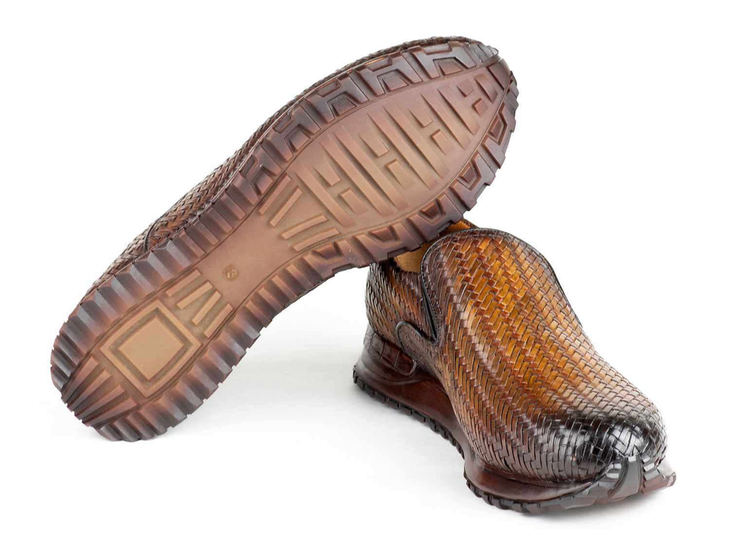 A pair of Paul Parkman Men's Brown Woven Leather Slip-On Sneakers (LW204BRW) featuring a textured sole and tan lining.