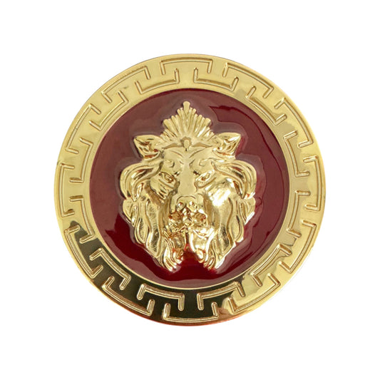 The Matiste Burgundy/Gold Belt Buckle 40mm B40 features a raised lion head at its center, gold-tone finish, and a geometric Greek key border, inspired by Italian luxury style. Brand: Matiste.