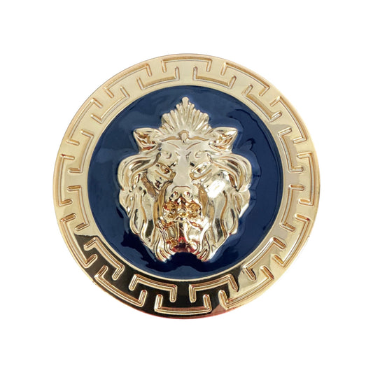 The Matiste Navy/Gold Belt Buckle 40mm B40 by Matiste features a round gold and navy enamel design with a raised lion's head at the center and a geometric border pattern.