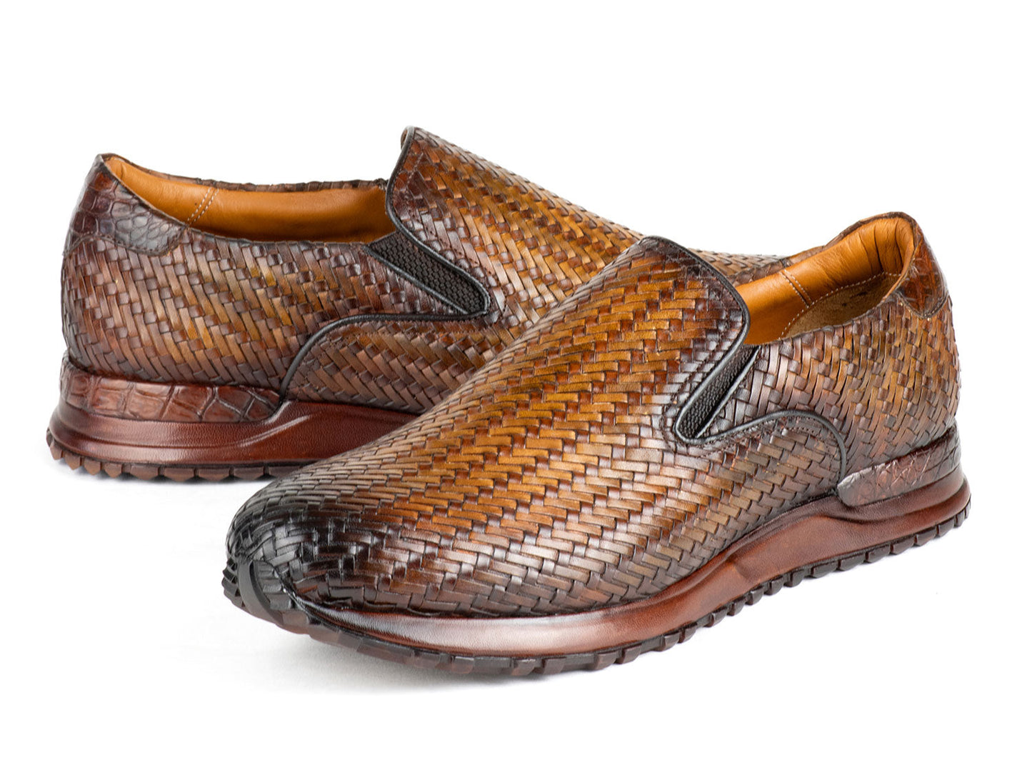 A pair of Paul Parkman Men's Brown Woven Leather Slip-On Sneakers (LW204BRW) featuring a textured sole and tan lining.