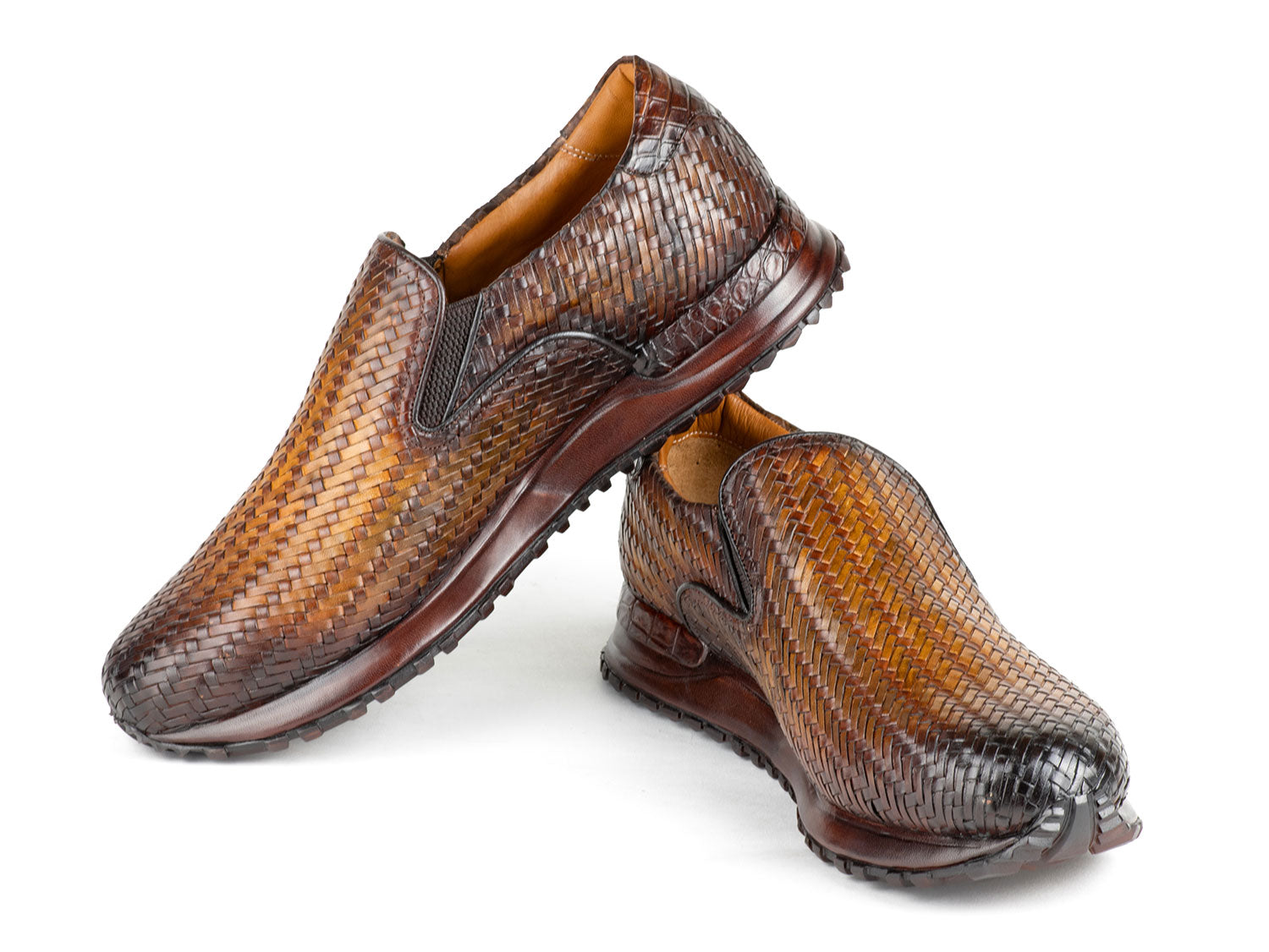 A pair of Paul Parkman Men's Brown Woven Leather Slip-On Sneakers (LW204BRW) featuring a textured sole and tan lining.