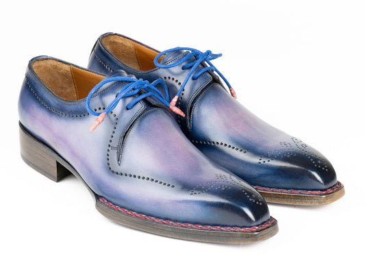 Discover the Paul Parkman Men's Hand-Welted Pink & Navy Leather Derby Shoes (Model 599F67), expertly crafted with hand-painted leather featuring a gradient blue finish, adorned with blue laces and accentuated by red stitching along the sole.