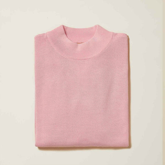 The Inserch Cotton Blend Mock Neck Sweater Pink 4308-00062 features a light pink hue, soft cotton-acrylic blend, round neckline, and classic mock neck style, neatly folded on a cream-colored surface.