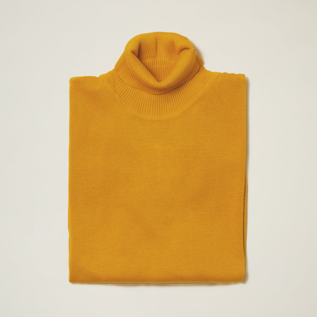 The Inserch Cotton Blend Turtleneck Sweater Mustard 4708 by Inserch is shown neatly folded on a plain light background, highlighting its soft cotton-acrylic blend and mustard yellow color.