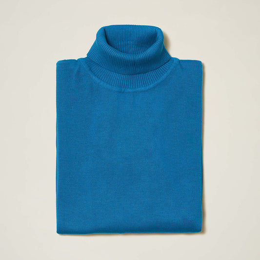 The Inserch Cotton Blend Turtleneck Sweater in True Blue (style 4708) by Inserch, made from a soft cotton-acrylic blend, is neatly folded and displayed against a plain light-colored background.