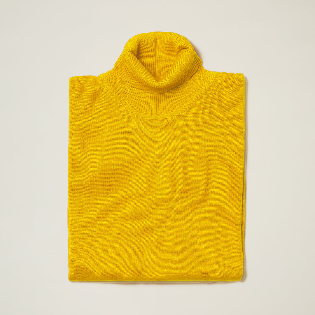 Folded orange Inserch Cotton Blend Turtleneck Sweater 4708, ideal for cozy fall days, showcased on a light background.
