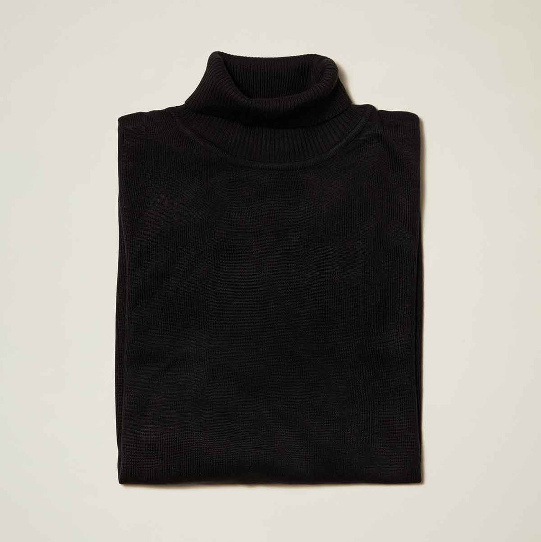 The Inserch Cotton Blend Slim Fit Turtleneck Sweater Black 4808 by Inserch is neatly folded on a light surface, crafted with anti-pilling fabric for lasting style.
