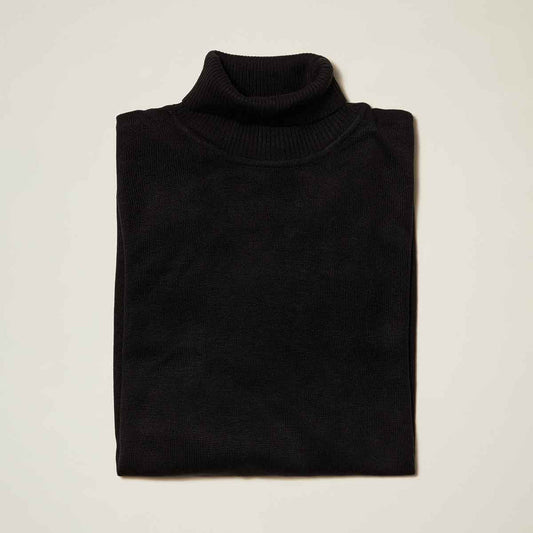 The Inserch Cotton Blend Slim Fit Turtleneck Sweater Black 4808 by Inserch is neatly folded on a light surface, crafted with anti-pilling fabric for lasting style.